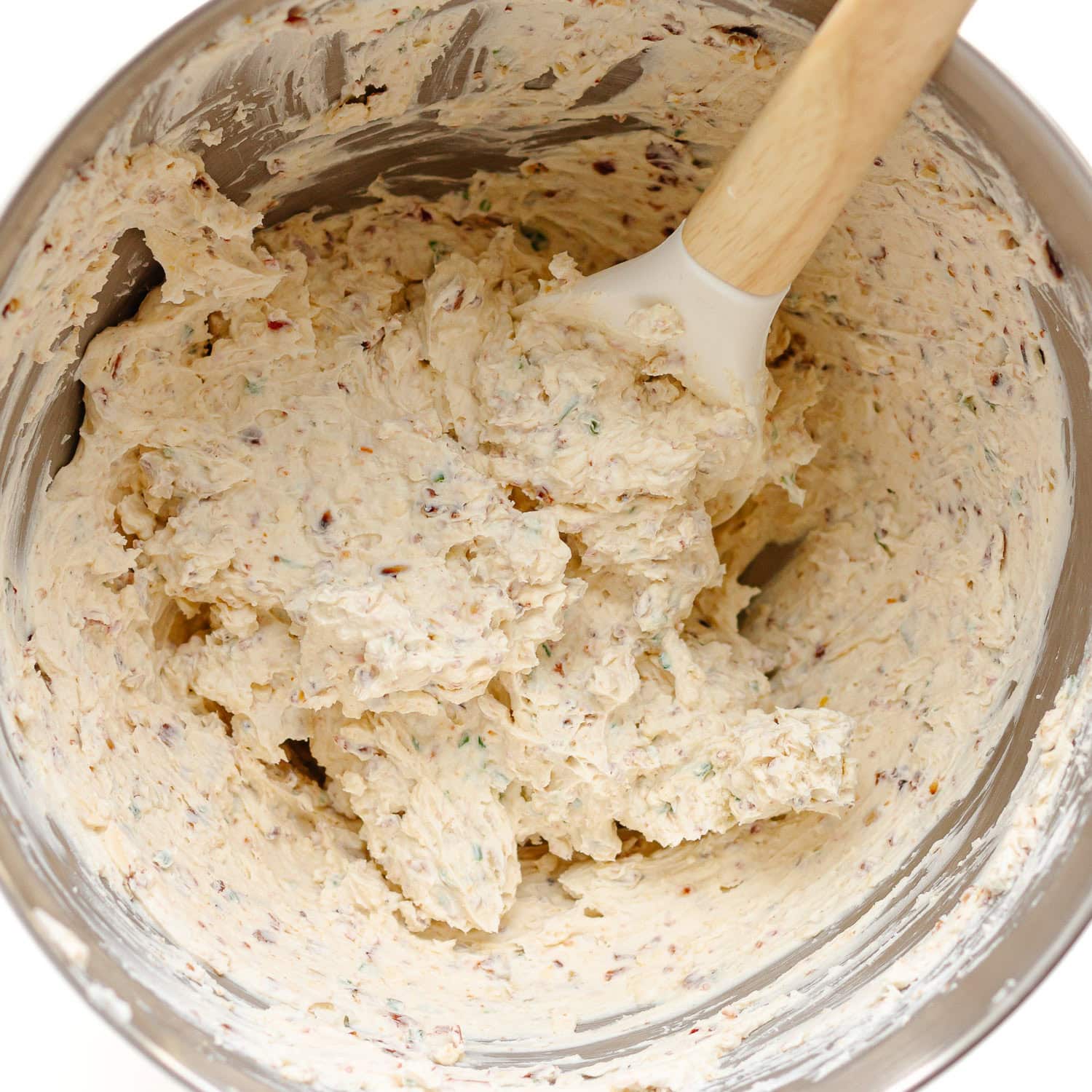 Cheese ball mixture being combined in stainless steel bowl.