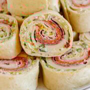 Pile of Italian pinwheels on a serving plate.
