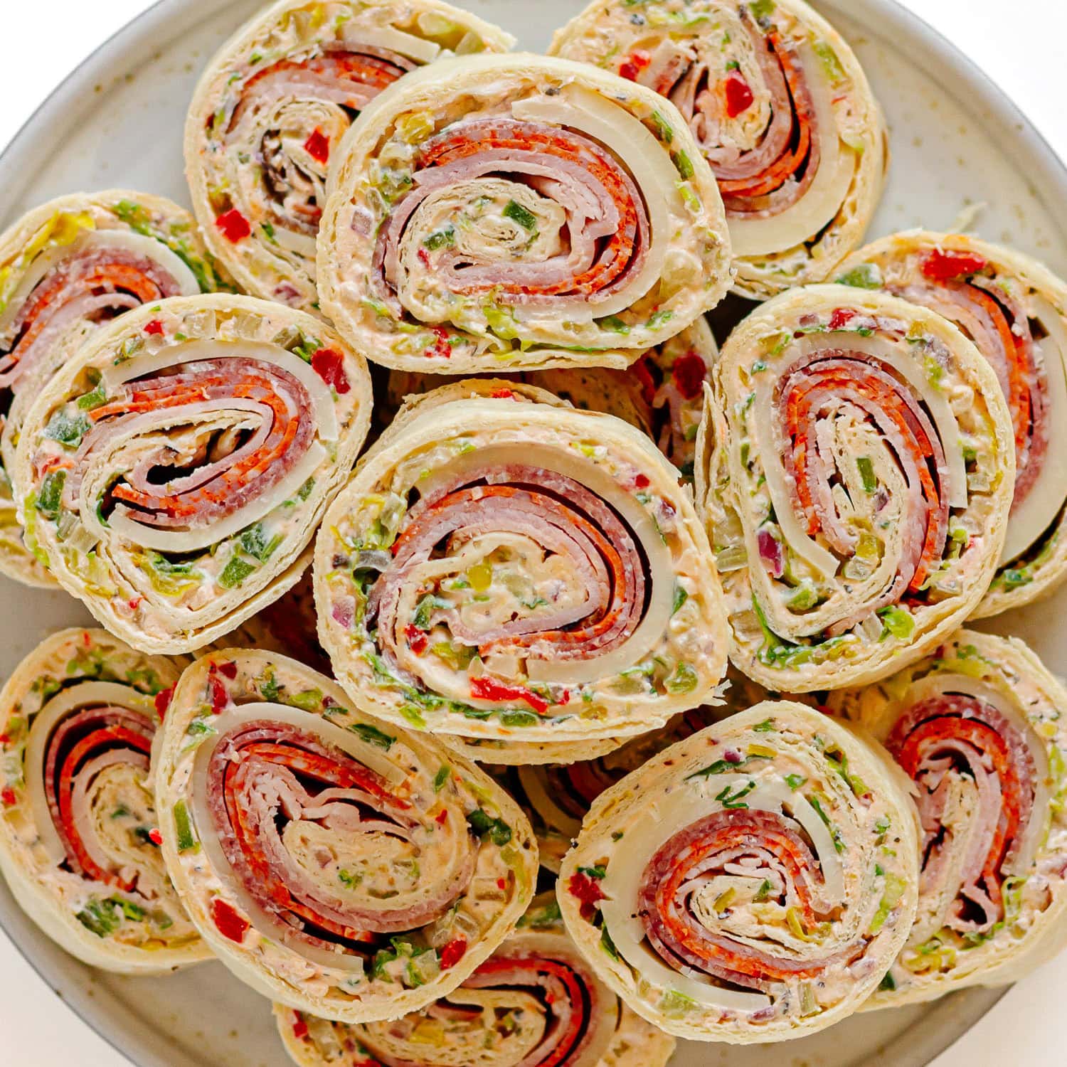 A plate of Italian pinwheel sandwiches.
