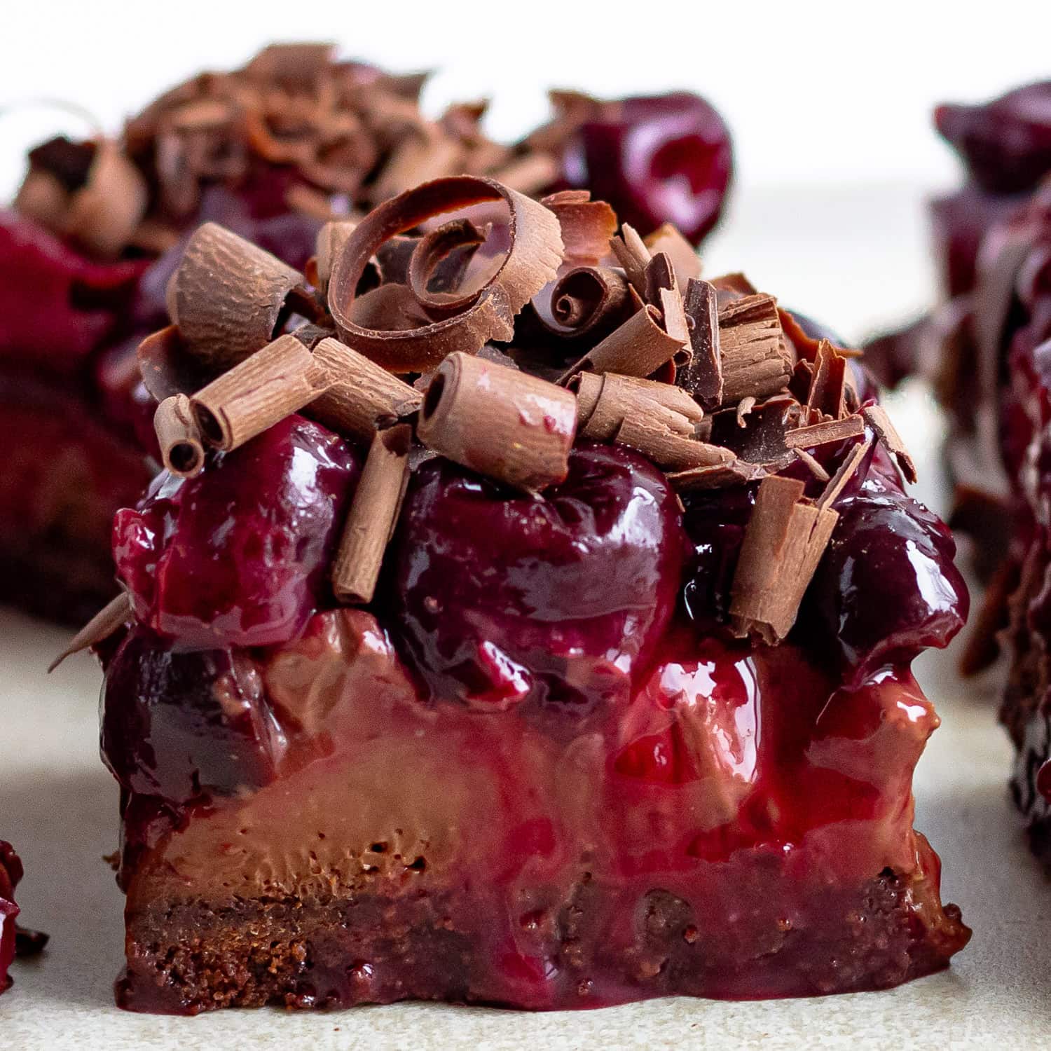 Closeup of a chocolate cherry cheesecake bar.