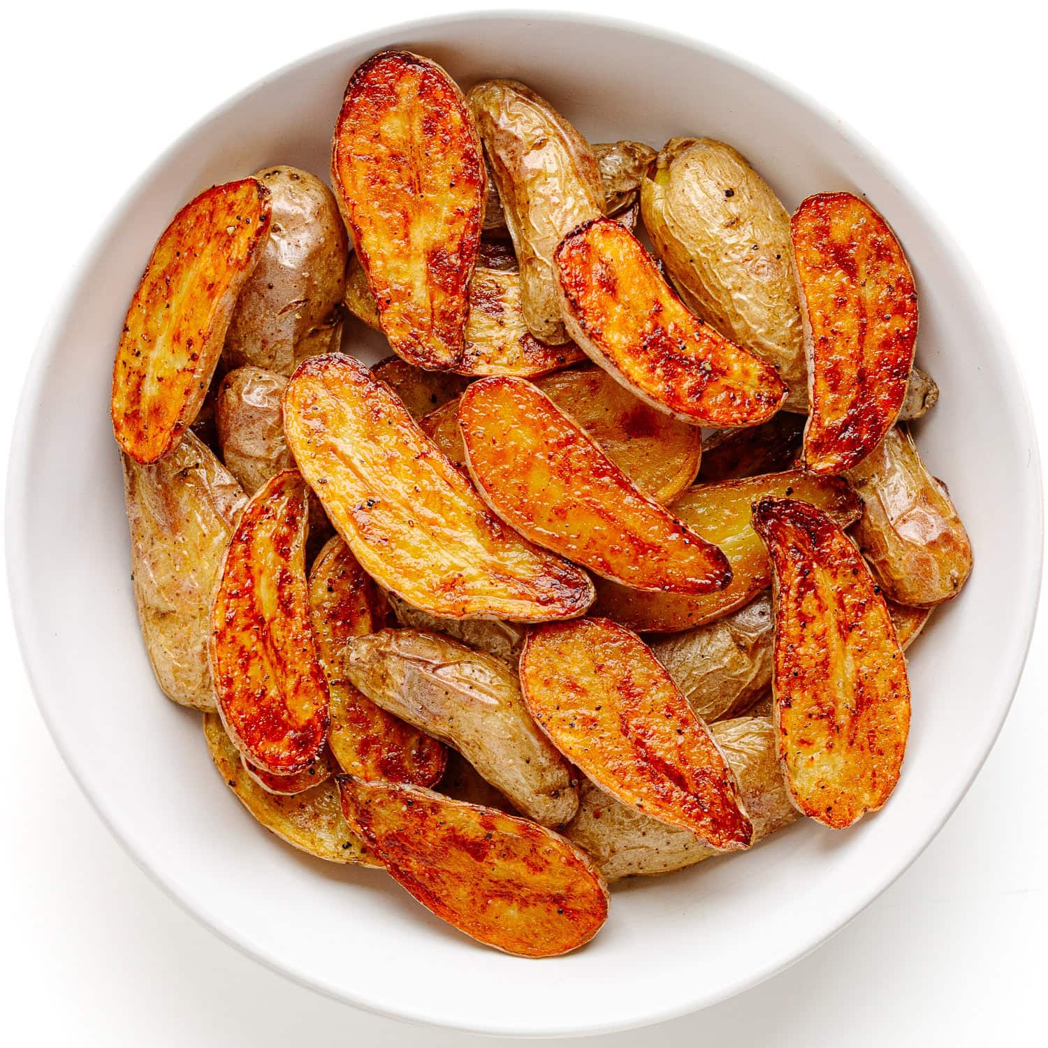 Truffle roasted fingerling potatoes in a white serving bowl.