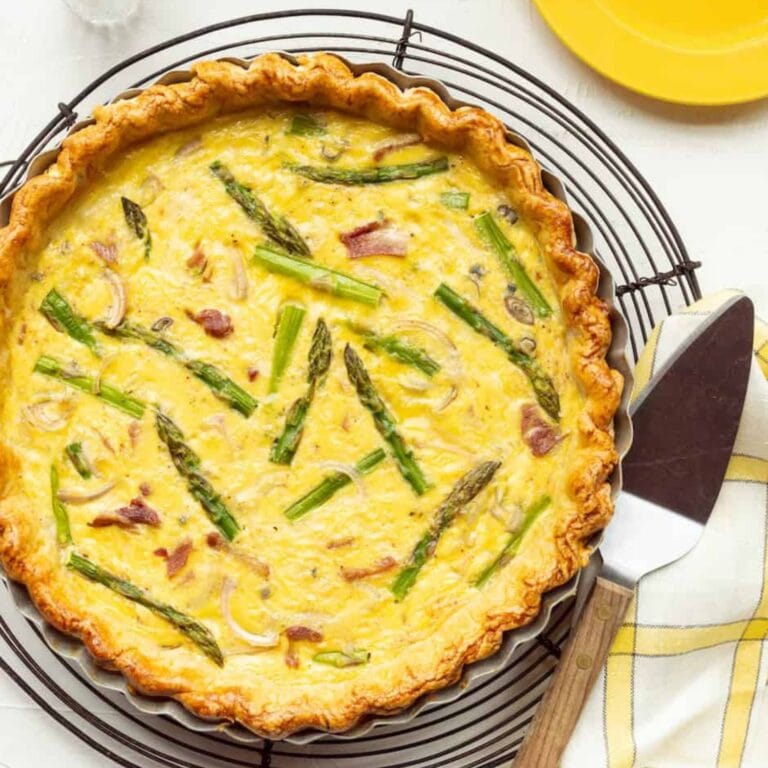 Ham and asparagus quiche on a cooling rack.