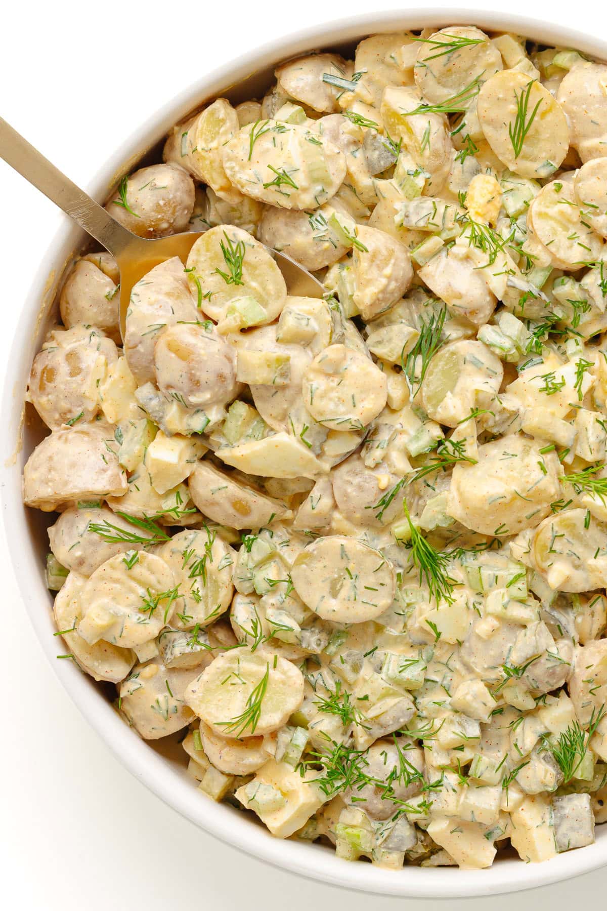 Serving bowl of creamy dill pickle potato salad.